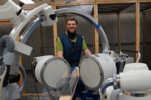 Here I am behind the two C-arm fluoroscopes.  In front of the scopes, you can spy the wooden plank walk-way for the rats, and an acrylic box that the rats will walk or run through in the vicinity of the X-ray fields.
